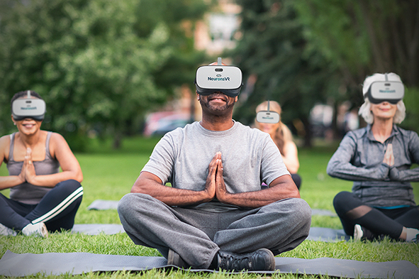 a group of seniors is attending a yoga class outdoors with the use of Virtual Reality Technology