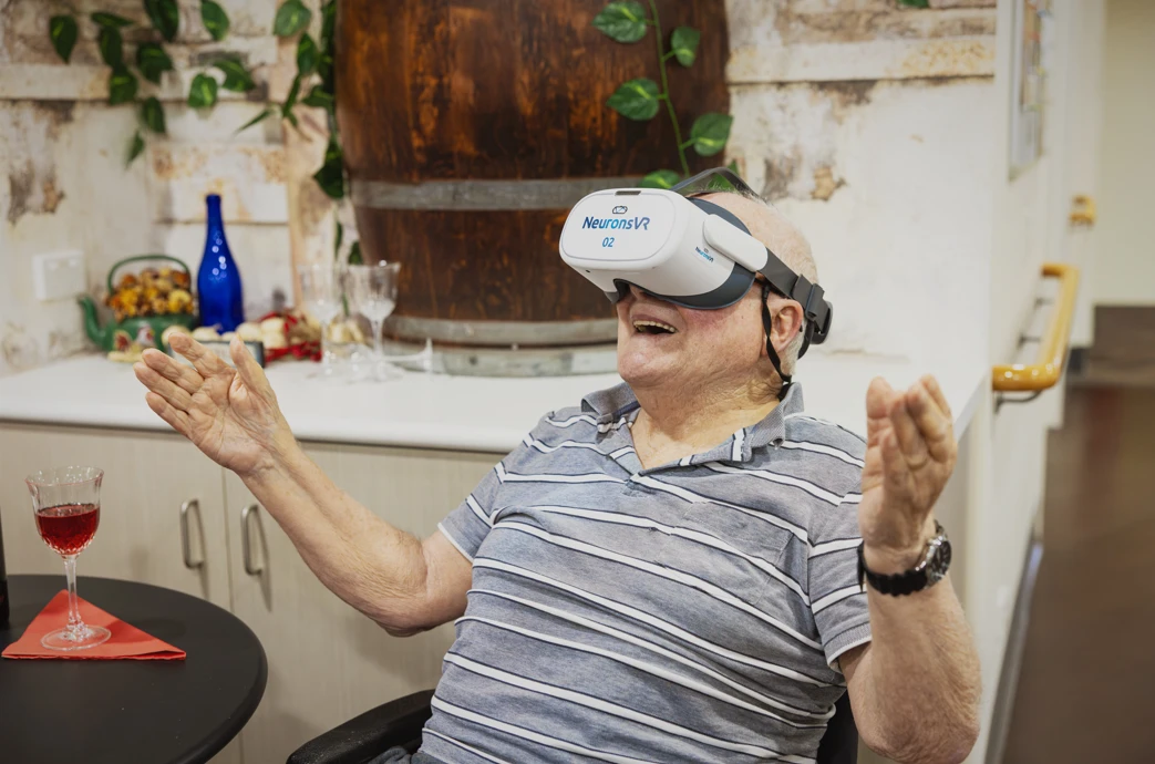 Elderly man using NeuronsVR in aged care home