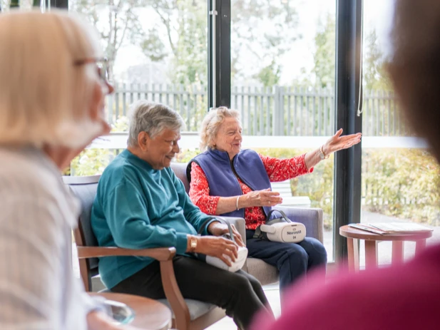 elderly women holding neuronsvr in residential care home 2